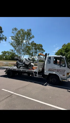Motorbike secured on the Evolution tilt tray on a sunny day