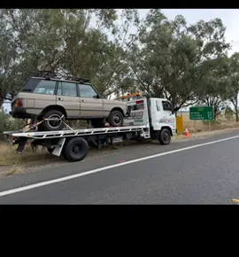 Range Rover Classic on the tilt tray on a country road