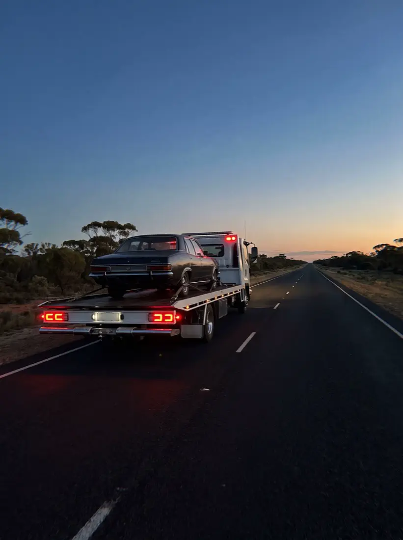 The loaded tray heading down a long straight highway at dusk